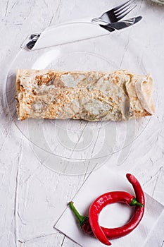 Vegetarian shawarma sandwich roll and red hot pepper. served in provence style. Healthy fast food. close up. flat lay