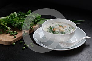 Vegetarian soup with green peas , fresh parsley, dill