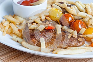 Vegetarian steak made from vegan seitan, cherry tomatoes and fries