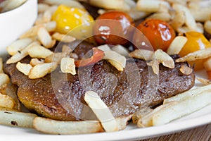 Vegetarian steak made from vegan seitan, cherry tomatoes and fries