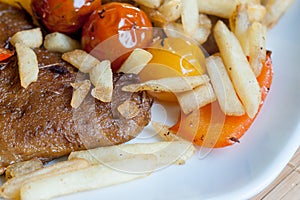 Vegetarian steak made from vegan seitan, cherry tomatoes and fries