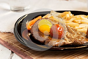 Vegetarian steak from vegan meat seitan, cherry tomatoes and fries