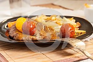 Vegetarian steak from vegan meat seitan, cherry tomatoes and fries