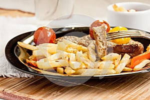 Vegetarian steak from vegan meat seitan, cherry tomatoes and fries