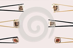 Vegetarian sushi minimal concept with creative copy space. Many chopsticks with plenty piece of rolled in nori dried edible