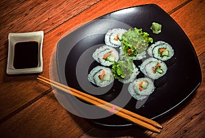 Vegetarian sushi roll on black plate