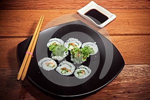 Vegetarian sushi roll on black plate