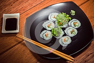 Vegetarian sushi roll on black plate