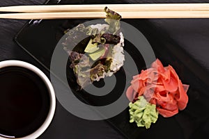 Vegetarian sushi roll over black stone table