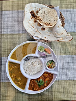 Vegetarian thali Indian food meal with rice and roti bread