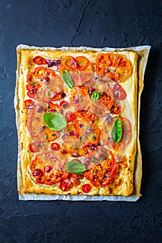 Vegetarian tomato tart or puffed pizza with herbs