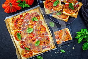 Vegetarian tomato tart or puffed pizza with herbs