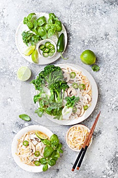 Vegetarian traditional Vietnamese soup Pho bo with herbs, rice noodles, broccolini, bok choy. Asian food concept.