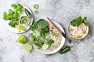 Vegetarian traditional Vietnamese soup Pho bo with herbs, rice noodles, broccolini, bok choy. Asian food concept.