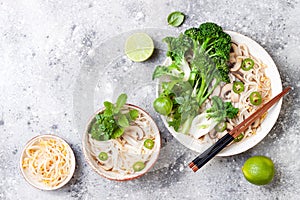 Vegetarian traditional Vietnamese soup Pho bo with herbs, rice noodles, broccolini, bok choy. Asian food concept.