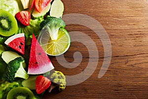 Vegetarian and vegan diet month in january called Veganuary. healthy raw vegetables and fruits on wooden background.