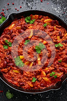 Vegetarian vegan mince chili con carne served in cast iron skillet pan