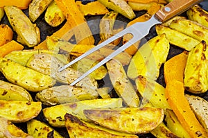 Vegetarian vegetable dish, potato wedges and pumpkin, baked grill.