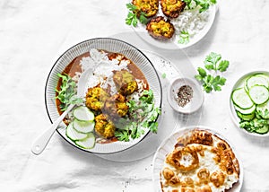 Vegetarian vegetable kofta with rice and curry sauce. Bottle gourd and zucchini fritters. Healthy vegetarian food on light backgro