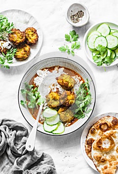 Vegetarian vegetable kofta with rice and curry sauce. Bottle gourd and zucchini fritters. Healthy vegetarian food on light backgro