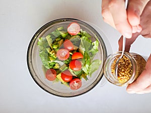 Vegetarian vegetable salad. Fresh salad flying to bowl in super slow motion. Avocado Tomato Salad