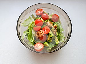 Vegetarian vegetable salad. Fresh salad flying to bowl in super slow motion. Avocado Tomato Salad