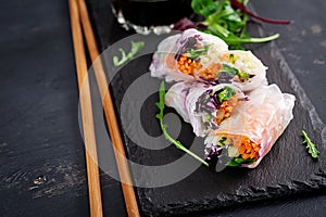 Vegetarian vietnamese spring rolls with spicy sauce, carrot, cucumber,