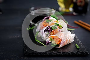 Vegetarian vietnamese spring rolls with spicy sauce, carrot, cucumber