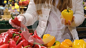 Vegetarian woman chooses vegetables at the market.