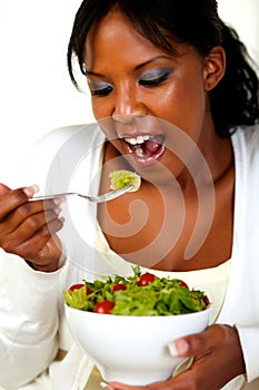 Vegetarian woman eating a attractive green salad