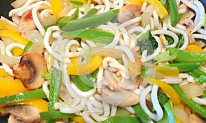 Vegetarian yellow green peppers mushroom noodle stir-fry