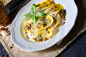 A Vegetariano italiano! Tortelli with roasted pine nuts and pesto basilico photo