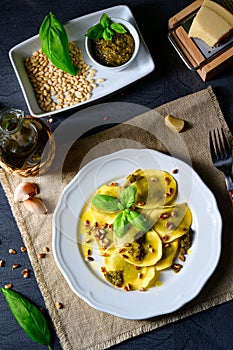 Vegetariano italiano! Tortelli with roasted pine nuts and pesto basilico photo