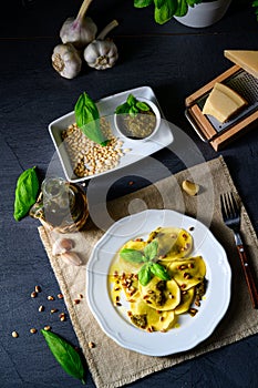 Vegetariano italiano! Tortelli with roasted pine nuts and pesto basilico photo