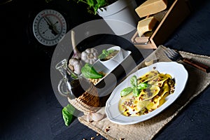 Vegetariano italiano! Tortelli with roasted pine nuts and pesto basilico photo