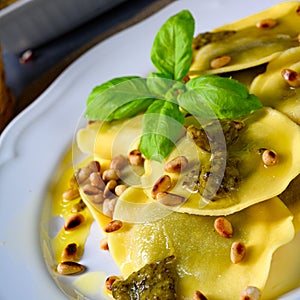 Vegetariano italiano! Tortelli with roasted pine nuts and pesto basilico photo