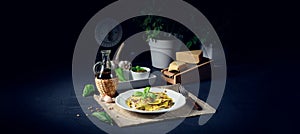 Vegetariano italiano! Tortelli with roasted pine nuts and pesto basilico photo
