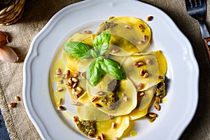 Vegetariano italiano! Tortelli with roasted pine nuts and pesto basilico photo