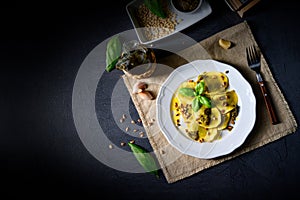 Vegetariano italiano! Tortelli with roasted pine nuts and pesto basilico photo