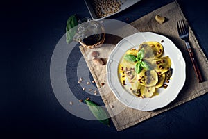 Vegetariano italiano! Tortelli with roasted pine nuts and pesto basilico photo