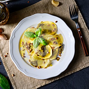 Vegetariano italiano! Tortelli with roasted pine nuts and pesto basilico photo