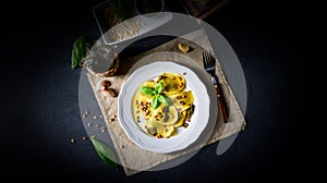 Vegetariano italiano! Tortelli with roasted pine nuts and pesto basilico photo