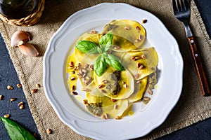 Vegetariano italiano! Tortelli with roasted pine nuts and pesto basilico photo