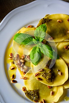 Vegetariano italiano! Tortelli with roasted pine nuts and pesto basilico photo