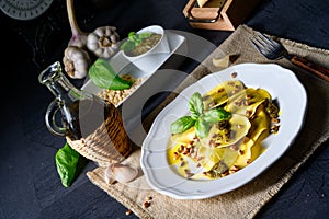 Vegetariano italiano! Tortelli with roasted pine nuts and pesto basilico photo