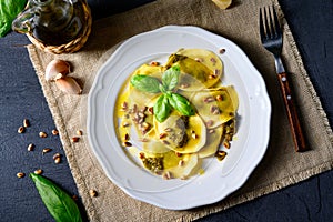 Vegetariano italiano! Tortelli with roasted pine nuts and pesto basilico photo