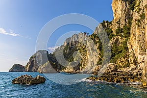 Vegetated sandstone cliffs and sea stacks along the east coast of the Island of Capri, Italy photo