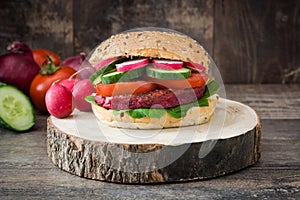 Veggie beet burger on a rustic wood