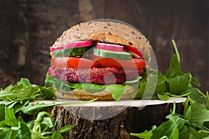 Veggie beet burger on a rustic wooden table