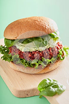 Veggie beet and quinoa burger with avocado dressing